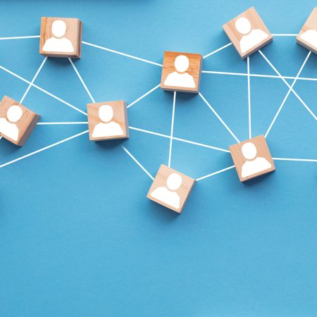 Wooden blocks connected together on a blue background. Teamwork concept Wooden blocks connected together on a blue background. Teamwork concept